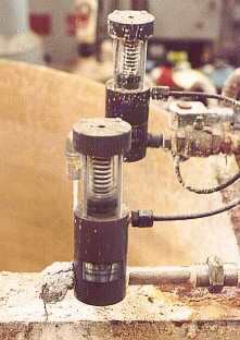 In the photo, the large dark grey PVC shutoff valves are just about the only items not affected by the highly corrosive atmosphere. These heavy-duty valves are only remotely related to the cheap white "swimming pool valves" most people associate with plastics.